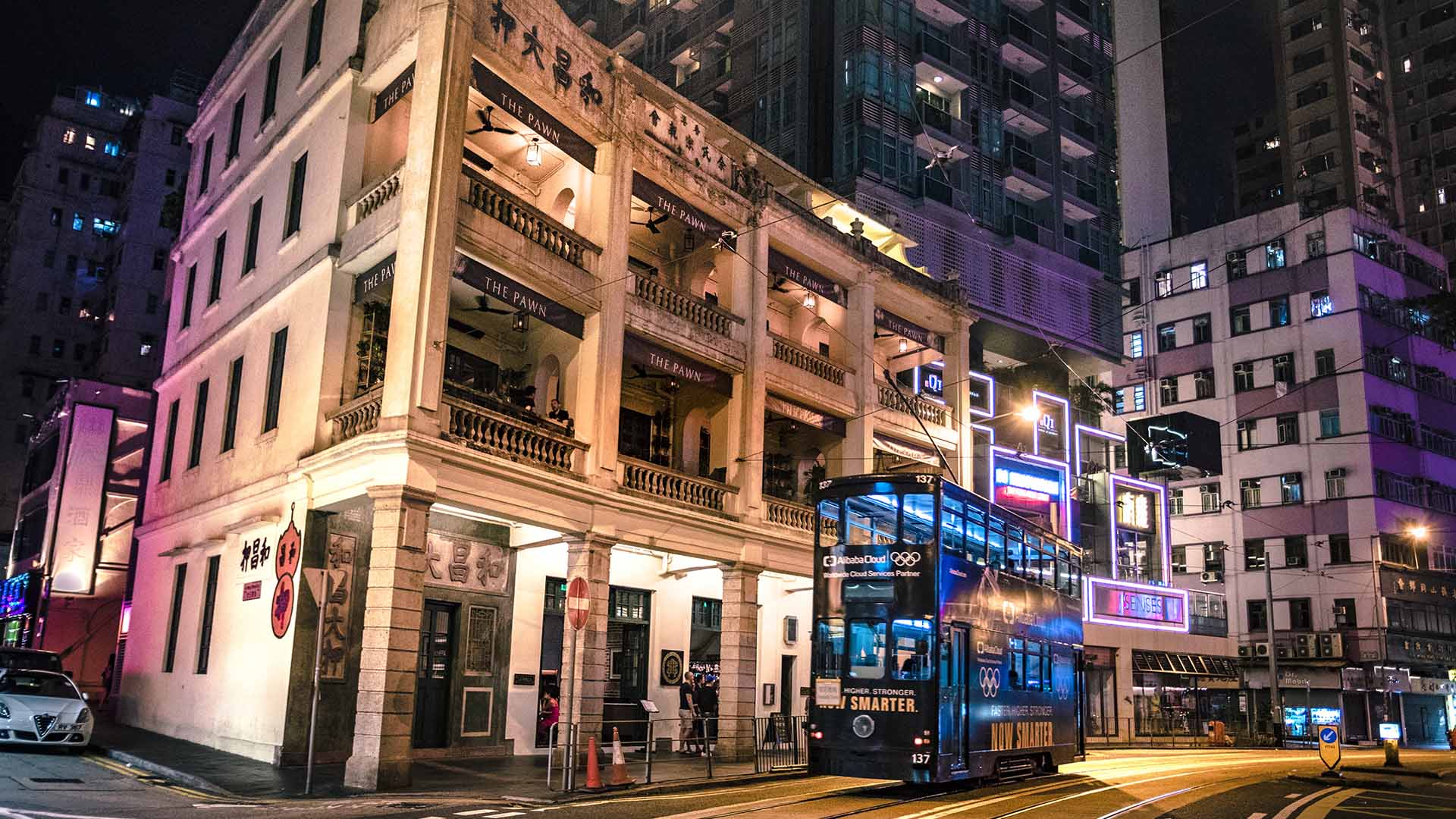 Hong Kong Island skyline overlooking Victoria Harbour at sunset.